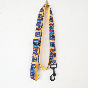 Blue-and-yellow geometric dog leash with yellow lining and black swivel clip