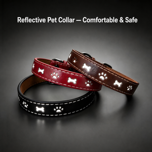 Red, brown and black reflective paw-print dog collars in low light