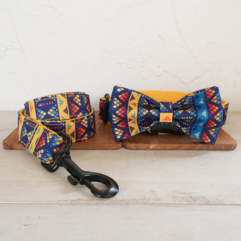 Geometric dog collar and leash set with a matching blue-and-yellow bow tie
