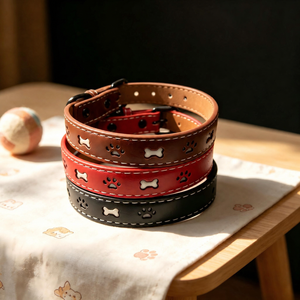Brown, red and black reflective paw-print dog collars stacked together